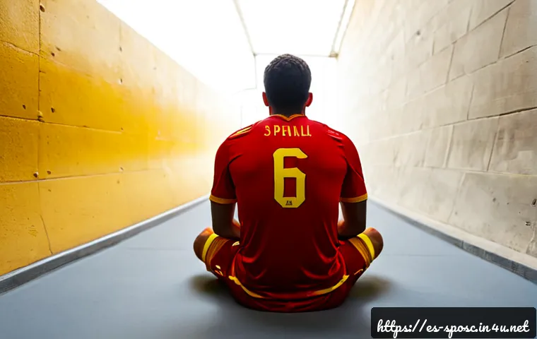 스포츠 심리학 기법 - Photorealistic Spanish football player seated alone in a quiet stadium tunnel before a match, eyes c...